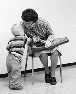 Jessica with autoharp and child